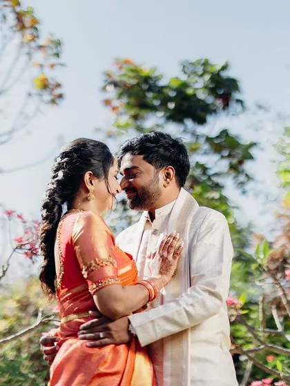 A candid moment between the couple amidst lush greenery. We love finding natural, beautiful spots for portraits that feel relaxed and authentic.