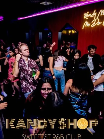 The neon sign 'Kandy Made Me Do It' overlooks the dance floor. It perfectly captures the fun and carefree vibe of my Saturday night sets.