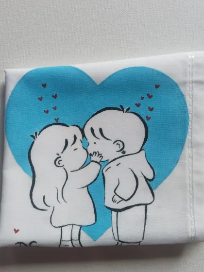This doodle captures a sweet kiss against a big blue heart. I use high-quality fabric paints to ensure the colors are bright and the art lasts.