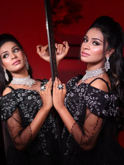 A close-up of the black ball gown, showing the beautiful contrast between the dark tulle and the sparkling silver embroidery, reflected in the mirror.