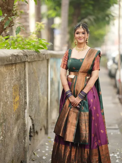 This angle shows the beautiful draping of the saree and the intricate hairstyle.
