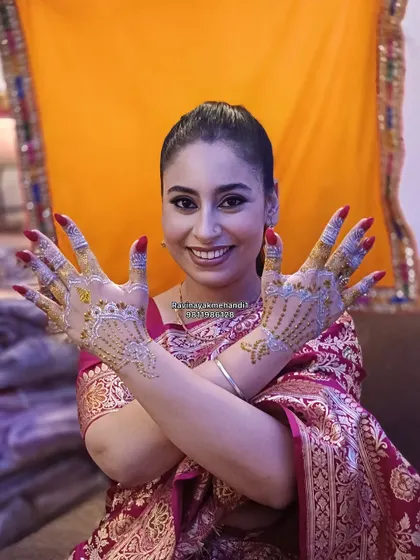 A happy client showing off her beautiful white and gold glitter mehndi. This is a fantastic, temporary option for a glamorous evening look.