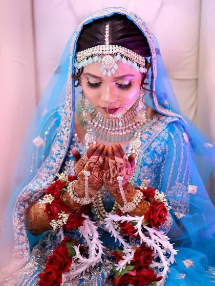 Another beautiful shot of the bride in prayer, the soft lighting creating a divine glow around her.