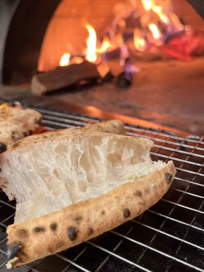Another angle on our fire-kissed crust. We love showing off the texture that makes our Neapolitan pizza so special.