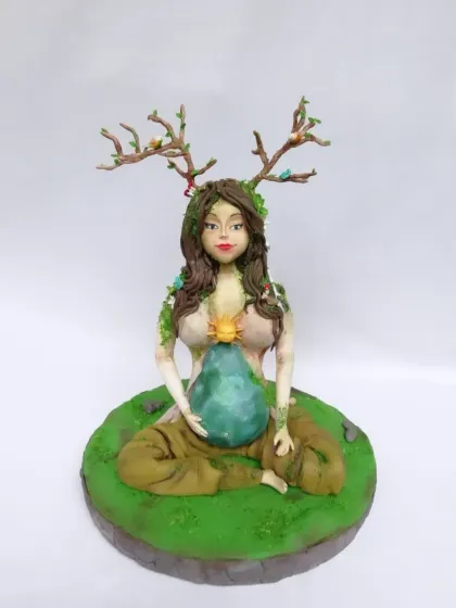 This Mother Earth figurine is a piece of pure sugar art that I'm very proud of. It shows the level of detail and sculpting you can achieve with gumpaste, from the facial features to the delicate branches and leaves.