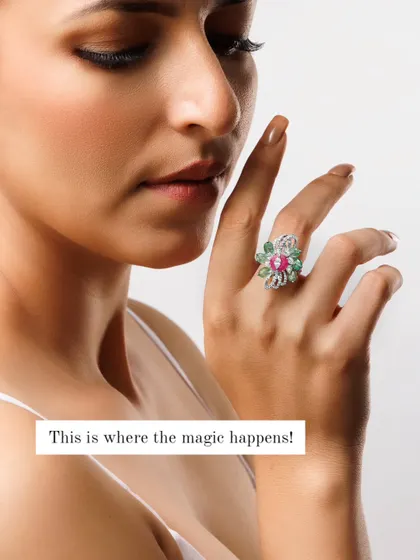 A clean, bright shot that highlights a floral-design diamond and ruby ring. The caption "This is where the magic happens" refers to the moment where light, detail, and vision align to create a perfect product image.
