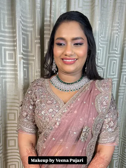 A beautiful smile from a happy client at her reception. The makeup is soft and luminous, with a focus on enhancing her natural features.