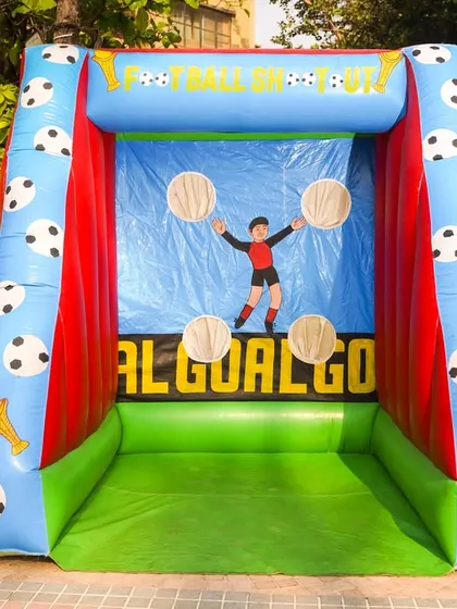 An inflatable football shootout game where kids can test their aim by kicking soccer balls at targets. A great addition for a sports-themed party.