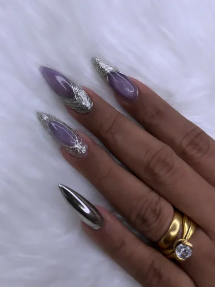 This is where nail art becomes high fashion. I created this dramatic look using sharp stiletto extensions, a soft lavender base, and striking 3D silver chrome accents for a futuristic and elegant finish.