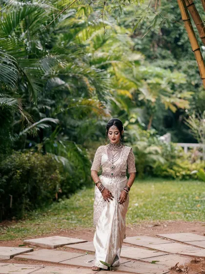 A full-length shot of the bride, showcasing how the elbow-length mehendi becomes a significant part of the bridal attire. It's an accessory that tells a story.