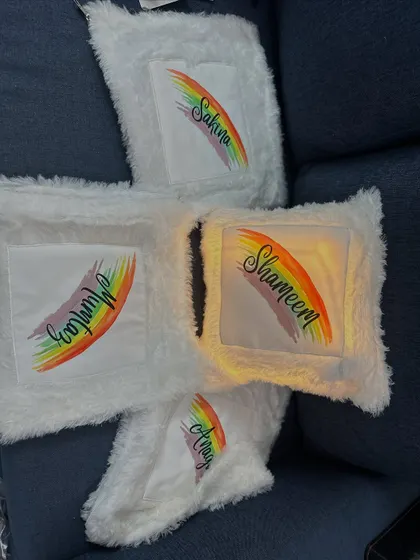 Another shot of the personalized rainbow cushions, perfect for gifting to a group of friends or siblings.