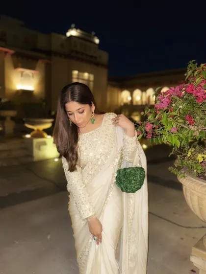 A close-up of the details. The delicate embroidery and the texture of the bag create a look that is both classic and interesting. As a bridal stylist, I focus on these small details that make a big impact.