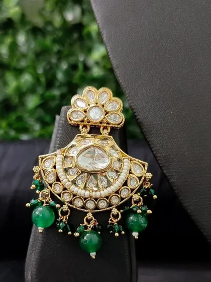A beautiful kundan chandbali earring with green bead drops. This rental piece is elegant and perfect for a sangeet or reception.