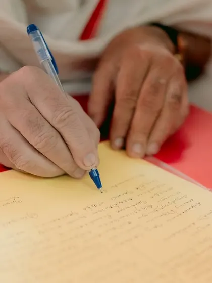 A close-up shot of the marriage contract being signed, a significant and official moment.