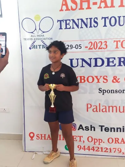 Eshitha proudly holds her doubles finalist trophy from the AITA NS U-12 tournament in Hyderabad.