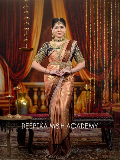 A full-length shot of the bride in a prayer-like pose, capturing the traditional essence of the look. The entire ensemble, from saree to jewelry, is perfectly coordinated.