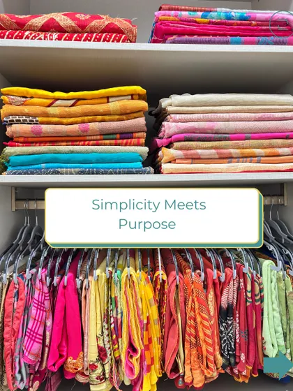 Simplicity meets purpose. A beautifully organized saree collection, with daily wear sarees hung for easy access and heavier ones folded neatly on shelves.