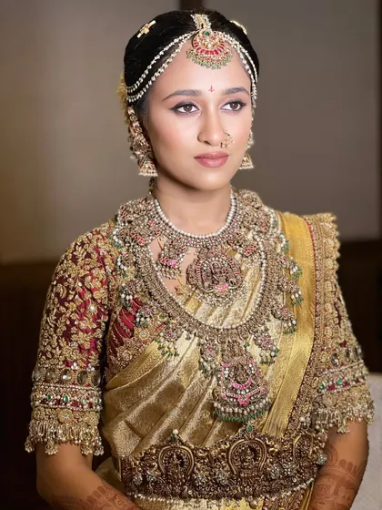 My course emphasizes creating a cohesive look. Notice how the makeup tones, with a subtle shimmer on the eyes and a defined lip, perfectly complement the warm gold of the saree and the antique finish of the jewelry.