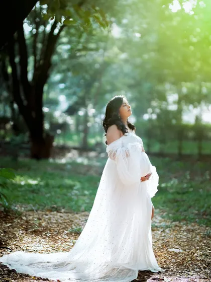 Bathed in ethereal sunlight, this mom-to-be looks up in a moment of quiet contemplation. I always look for these pockets of magical light during my outdoor sessions.
