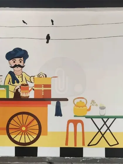 A charming mural for a cafe in Dehradun depicting a traditional Indian tea seller, or 'chaiwala'. This style of art is perfect for creating a nostalgic and local atmosphere.
