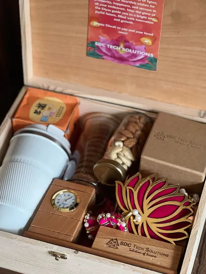 This angle highlights the branded wooden nameplate and desk clock included in the 'SDC Tech Solutions' Diwali gift box.