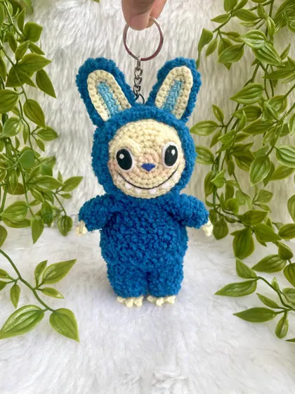 The trendy monster Labubu as a fluffy keychain. His unique look and soft texture make him a fun and eye-catching accessory.
