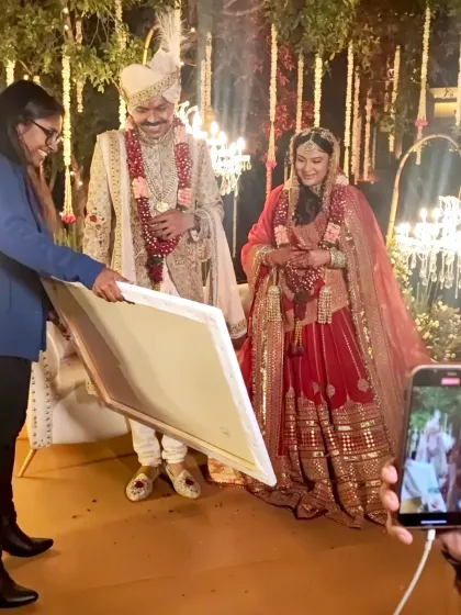 The moment of reveal. The bride's happy expression as she sees her wedding day captured on canvas is priceless.