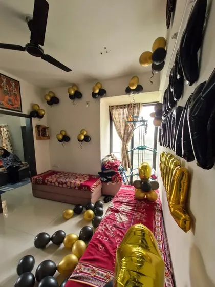 A side view of the 'Happy Birthday' wall decoration, showing the arrangement of the foil balloons.