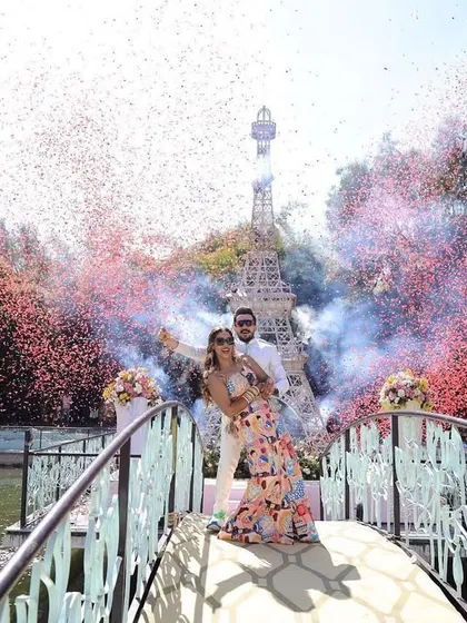 A romantic moment captured during a Paris-themed event. The confetti, smoke, and iconic backdrop make for an unforgettable photo opportunity.