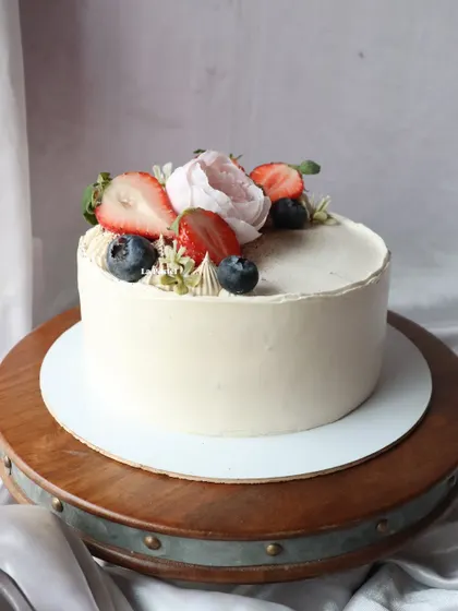 Another view of the berry and peony cake, showing the beautiful combination of fresh fruit and flowers.
