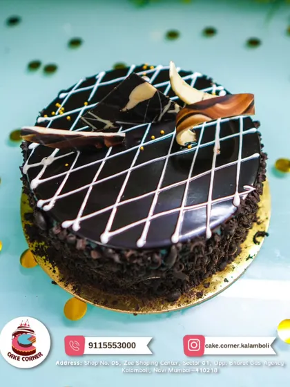 A delicious chocolate cake with a diamond pattern glaze and chocolate shards on top. A simple yet elegant choice for any occasion.