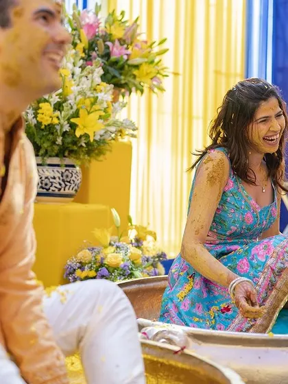 A candid moment of laughter from the bride during her fun-filled Haldi ceremony.