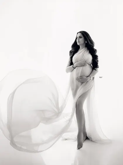 The same beautiful pose in timeless black and white. The monochrome edit really emphasizes the graceful lines and flow of the fabric.