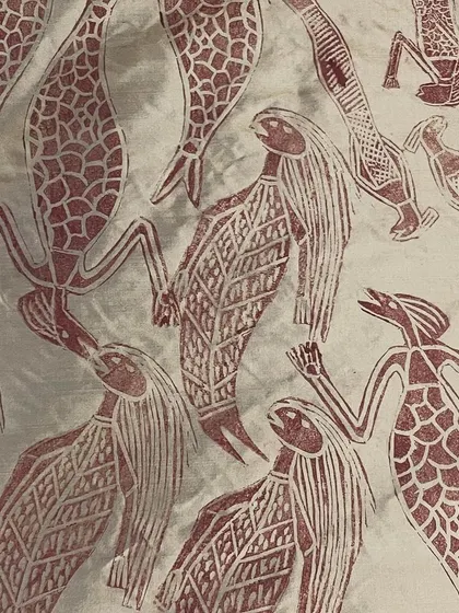 This is the story of a Yawkyawk (young woman mermaid) design by artist Janet Marawarr. Her original lino tile is being carefully translated into a woodblock by our carvers, preserving the story for our collaborative textile collection.