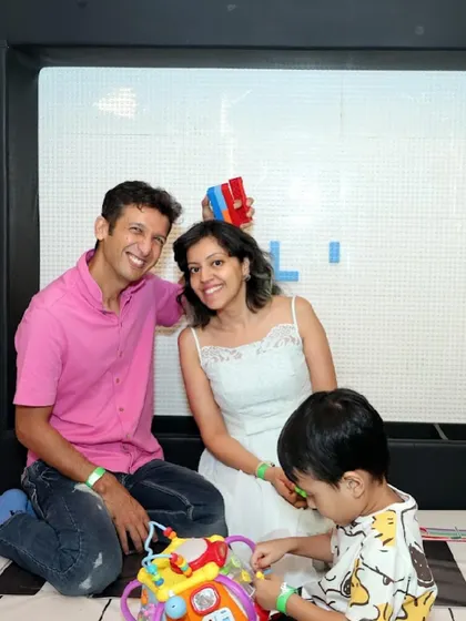 A family plays together in front of our interactive light wall.