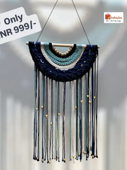 This semi-circle wall hanging in shades of blue is a beautiful, calming piece for any space. The wooden beads add a natural, earthy element.