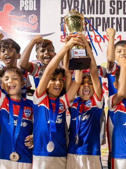 The U11 team roars with excitement as they lift the PSDL championship trophy. A fantastic end to the season for our junior blues.