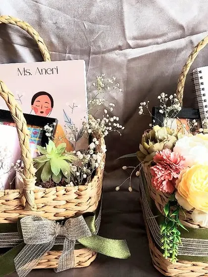 A beautiful basket hamper curated as a congratulatory gift. It includes a personalized notebook and mug, making it a thoughtful and unique present for any special occasion.