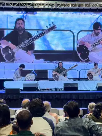 Our performance projected on a large screen during our USA tour. This setup is great for large venues, ensuring everyone in the audience gets a close-up view of the intricate fingerwork on the sitar.