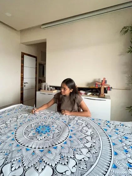 Customizing mandalas to reflect each client’s vision is a core part of my journey. Here I am working on a large blue and white piece in my studio.