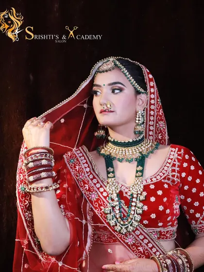 The grace of a bride is in her eyes. This stunning portrait captures the beauty of our model in a traditional red lehenga, with makeup that highlights her features perfectly.
