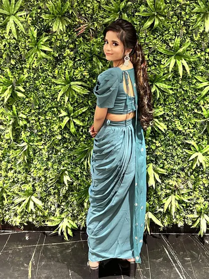 The back view of this fusion outfit shows the stylish tie-up detail of the blouse and the beautiful drape of the skirt. It's all about the little details.