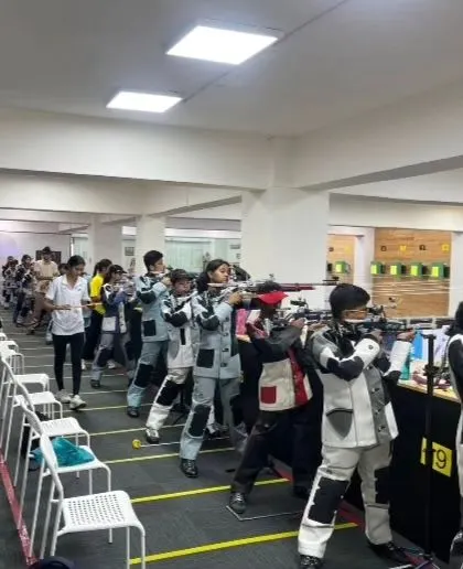 Young pistol and rifle shooters competing side-by-side. Our academy trains athletes across different shooting disciplines from the age of nine.