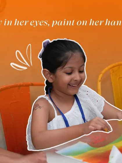 A smiling girl enjoys a pastel art session, the joy evident in her eyes as she works on her colorful creation.