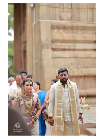 The bride and groom's entrance at the temple. For Vishnu Priya, we tailored every element of her makeup, hair, and draping to her exact vision of traditional beauty.