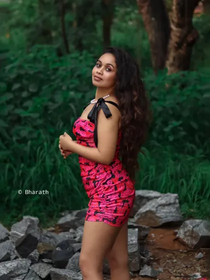 A side profile portrait in a natural, green setting. The soft, diffused light is very flattering for outdoor shoots.