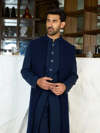 This navy Indo-Western outfit showcases a harmonious fusion of cultures. The long, textured jacket over a sleek kurta provides a modern look rooted in traditional flair.