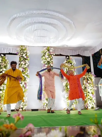 The men's group using dupattas as props for a fun and colorful performance. Props are a great way to add flair to a dance.