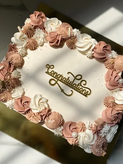 This beautiful sheet cake was for an engagement ceremony. I love the soft brown and white tones of the floral piping, finished with a golden butterfly for an elegant touch.