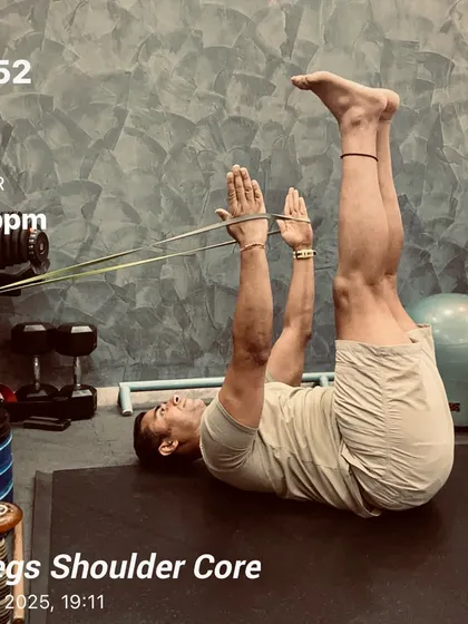 Tiredness is just a state of mind. A snapshot from a legs, shoulder, and core session, using a resistance band for a dead bug variation to enhance core engagement and shoulder stability.